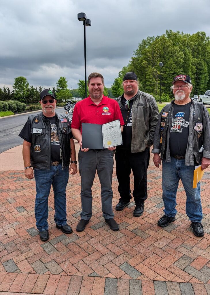 Brian Lorenz, Representative from the 60th Ohio House District, western Delaware County, presents a Proclamation to Chris Lappert, Region 9 Director, Ed Schetter, Executive Director and Mike Stock, Chair of the Board.
